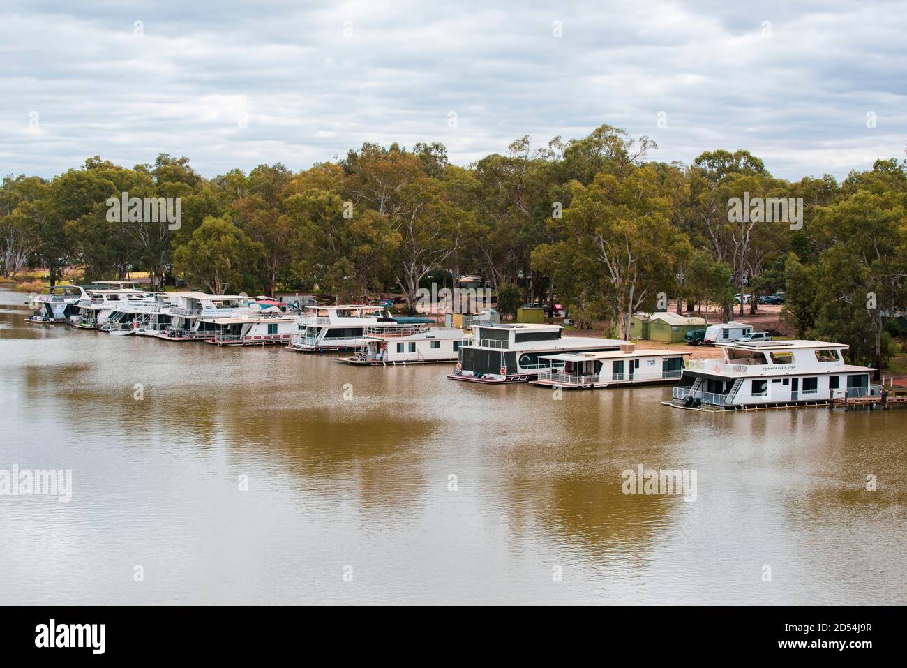 Houseboats moored on NSW side of the Murray river between Victoria and New South Wales in Australia Stock Photo
