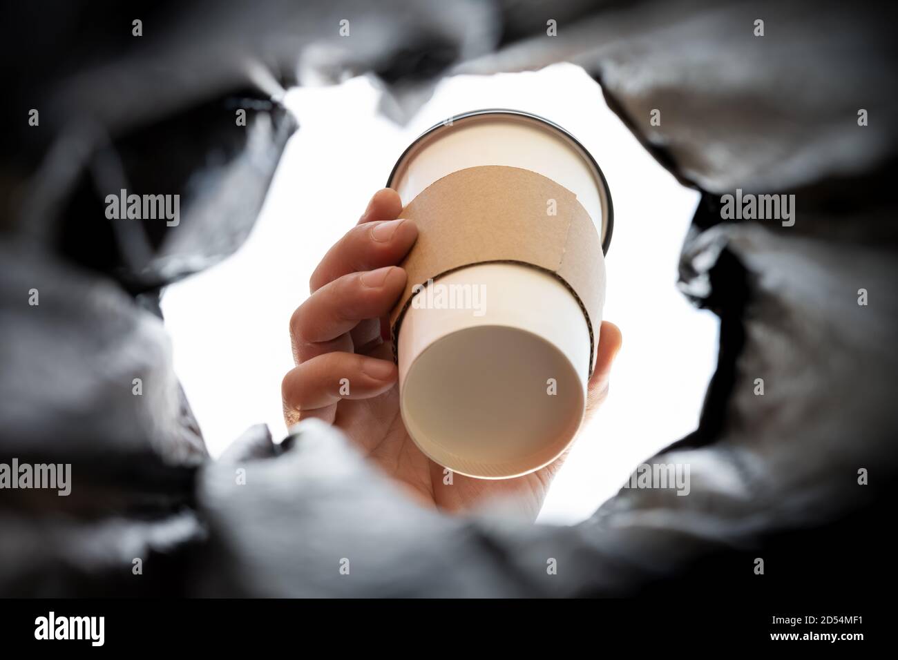 throwing a coffee cup to a rabbish bin concept of damaging the nature of using disposable things