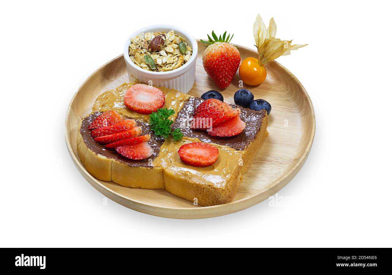 French toast sticks or honey toast stack on wooden plate with fresh fruit and vanilla ice cream on white isolated background with clipping path. Delic Stock Photo