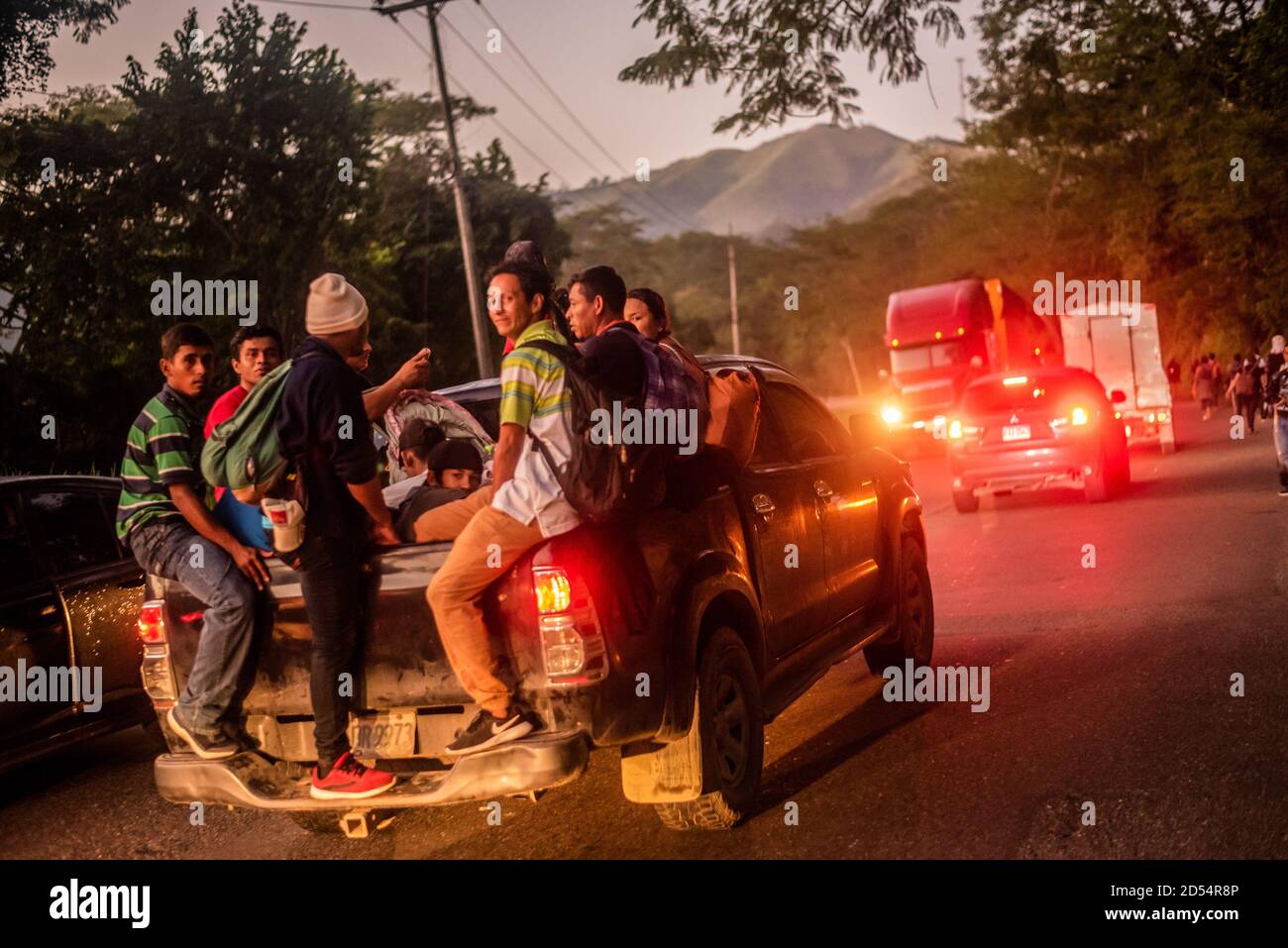 San Pedro Sula, Honduras. 15th Jan, 2020. Migrants leaving Honduras, the genesis of the Migrant Caravans load onto the back of a passing truck hoping to shorten the long journey to U.S. border. Migrants are fleeing from extreme poverty and gang violence, hoping to find a better life in the U.S. They must travel over 3,000 miles through Guatemala and Mexico, often times with nothing but the clothes on their back, to reach the border in Tijuana, Mexico where their fate is undecided. Credit: Seth Sidney Berry/SOPA Images/ZUMA Wire/Alamy Live News Stock Photo