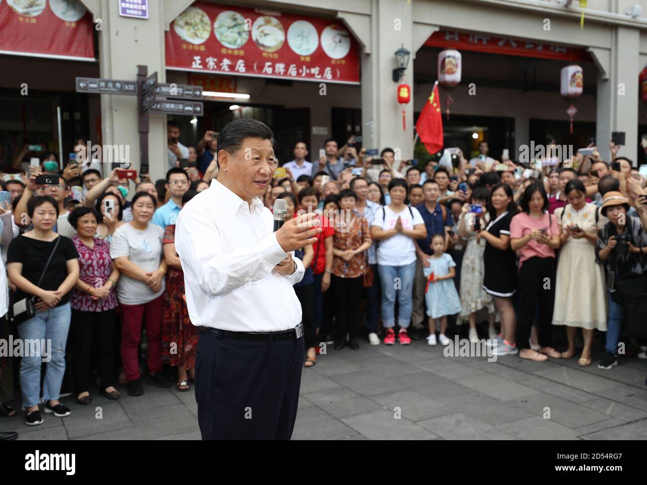 Chaozhou, China's Guangdong Province. 12th Oct, 2020. Chinese President Xi Jinping, also general secretary of the Communist Party of China Central Committee and chairman of the Central Military Commission, speaks with people while visiting a street lined with ancient memorial archways in Chaozhou, south China's Guangdong Province, Oct. 12, 2020. Xi on Monday arrived in Guangdong to begin an inspection tour of the province. Credit: Ju Peng/Xinhua/Alamy Live News Stock Photo