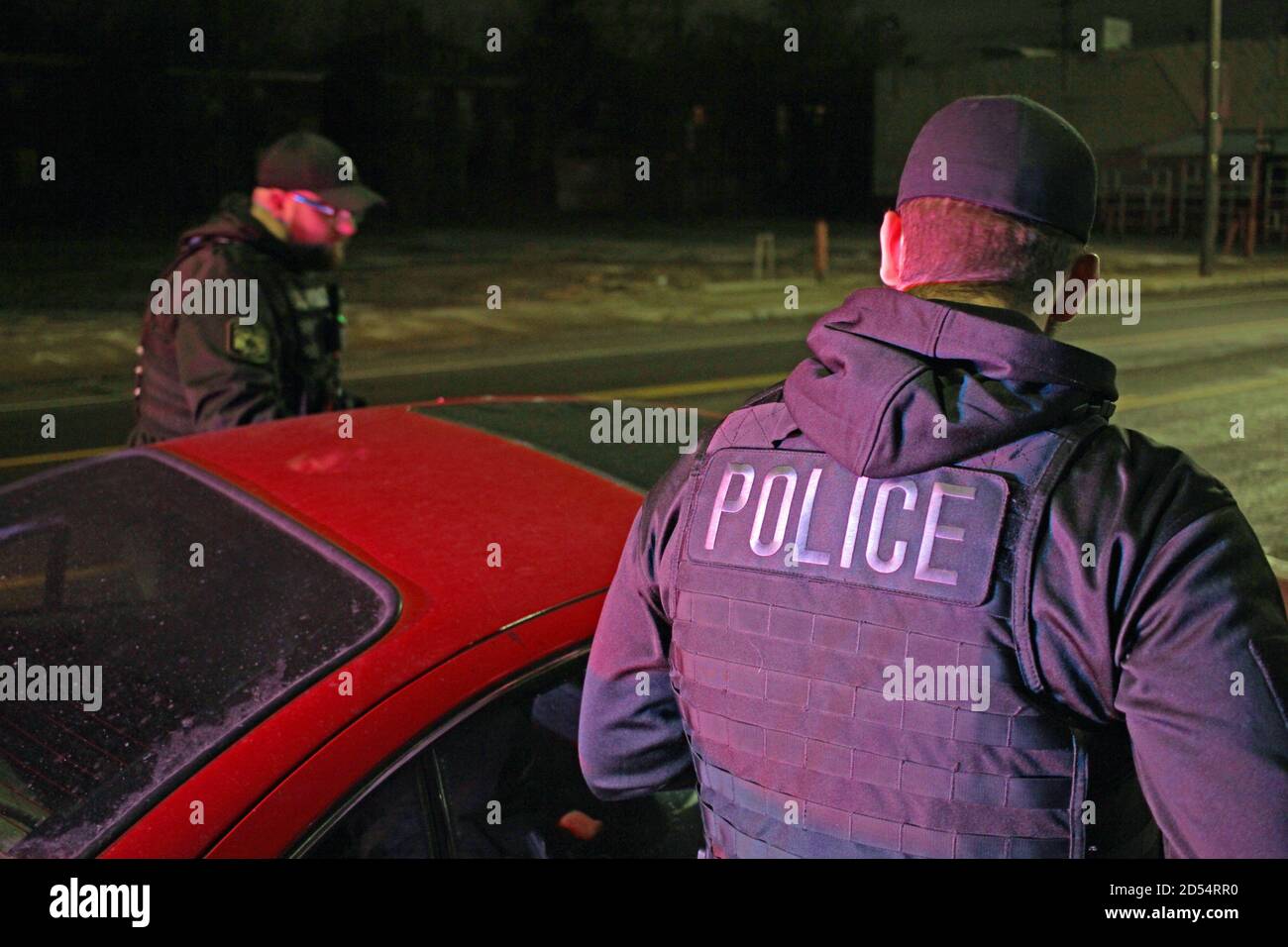 Detroit police officers speak to the driver of a car at night, Detroit, Michigan, USA Stock Photo