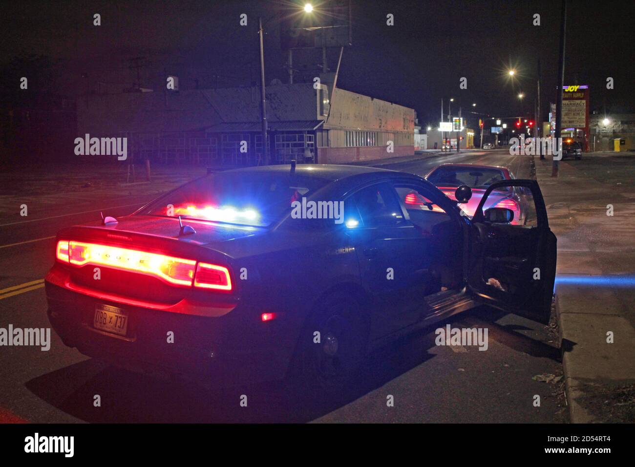Car stopped by police at night in Detroit, Michigan, USA Stock Photo