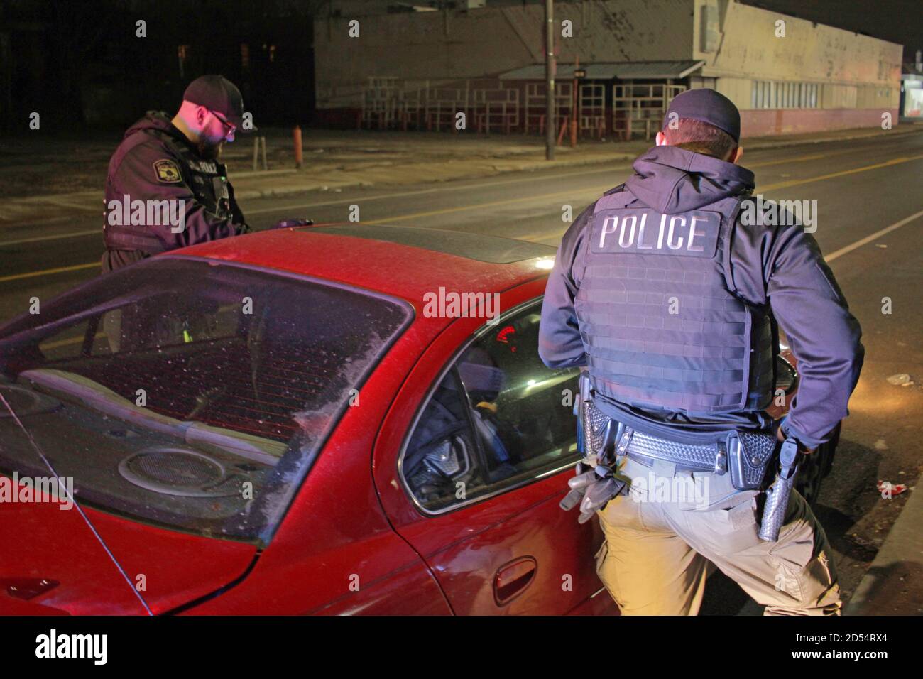 Detroit police officers speak to the driver of a car at night, Detroit, Michigan, USA Stock Photo
