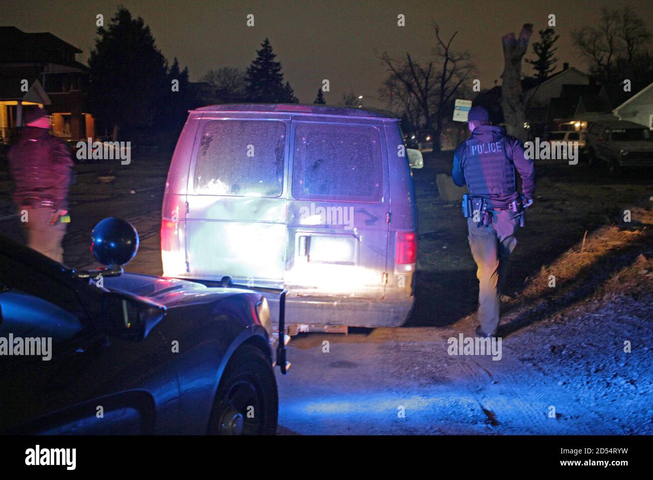 Detroit police officers appraoch the driver of a van at night, Detroit, Michigan, USA Stock Photo