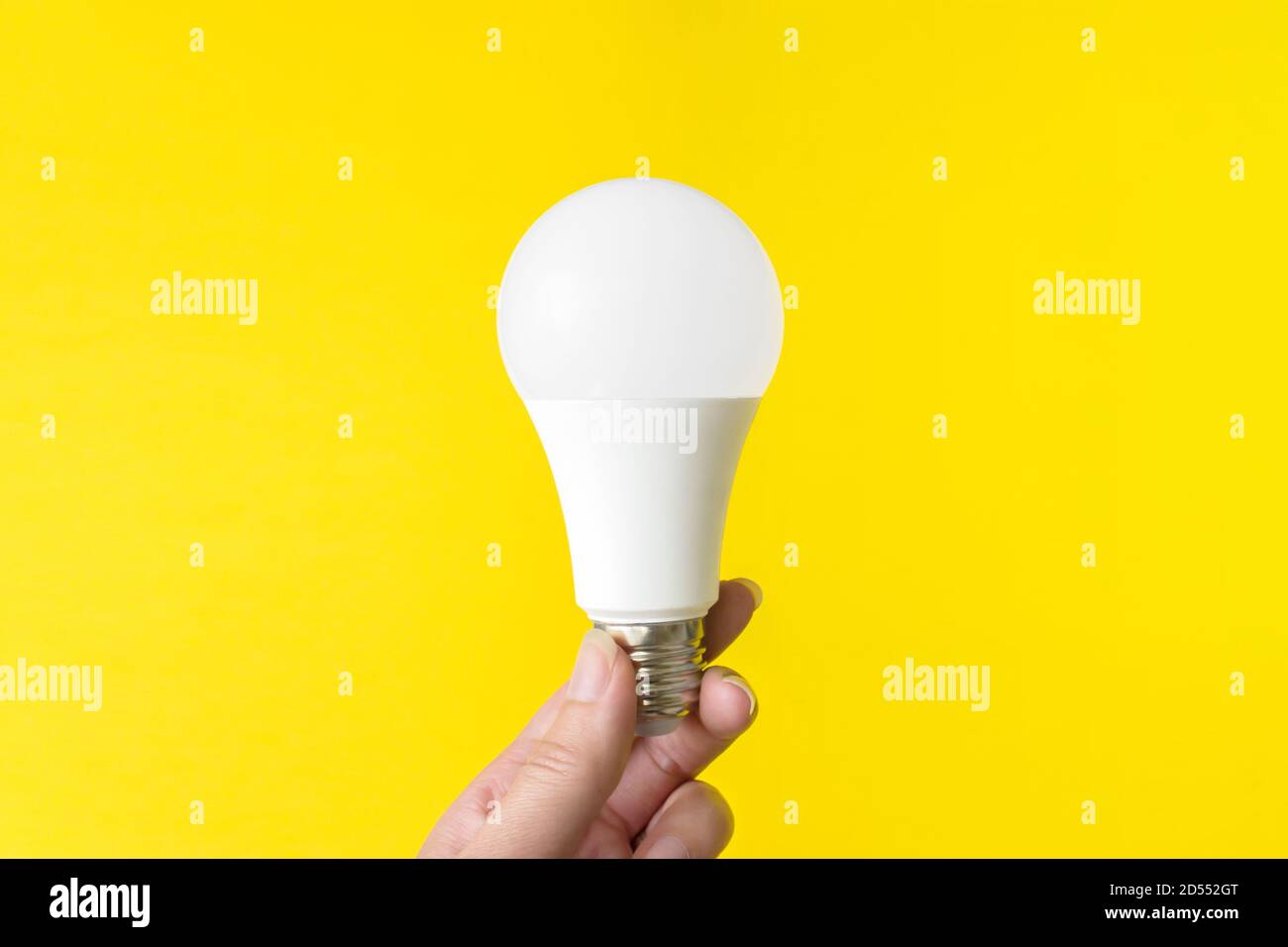 Led light bulb on a yellow background. New technology of energy, Eco power concept Stock Photo