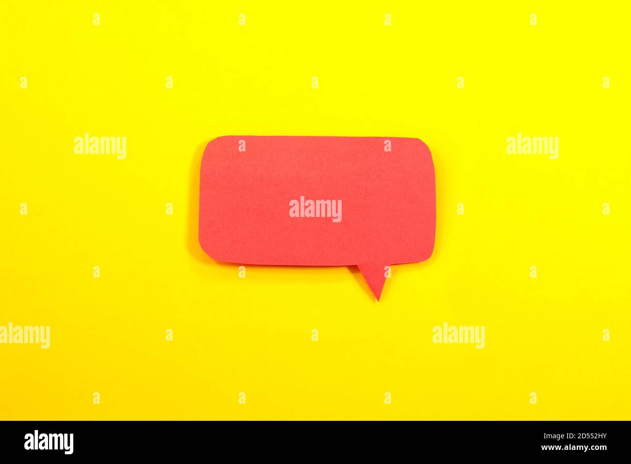 Red speech bubble on yellow background Stock Photo