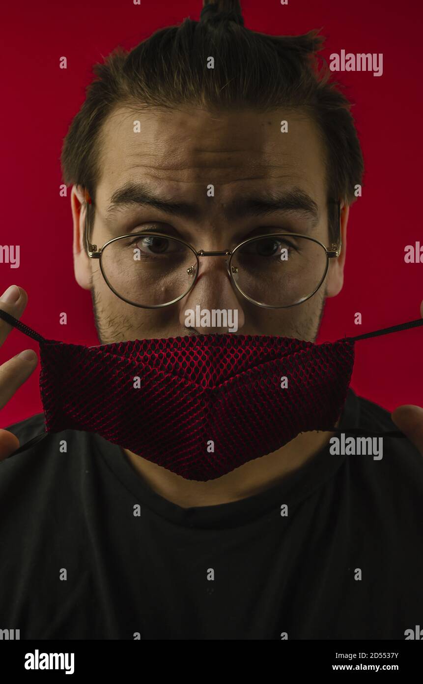 Young man putting on facemask hi-res stock photography and images - Alamy