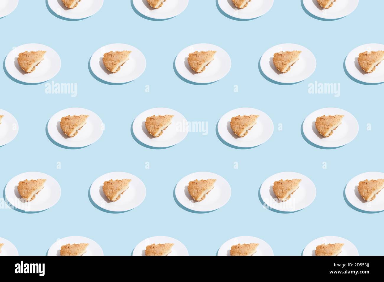 pattern of apple pie slices on white plate on blue background. trendy ...