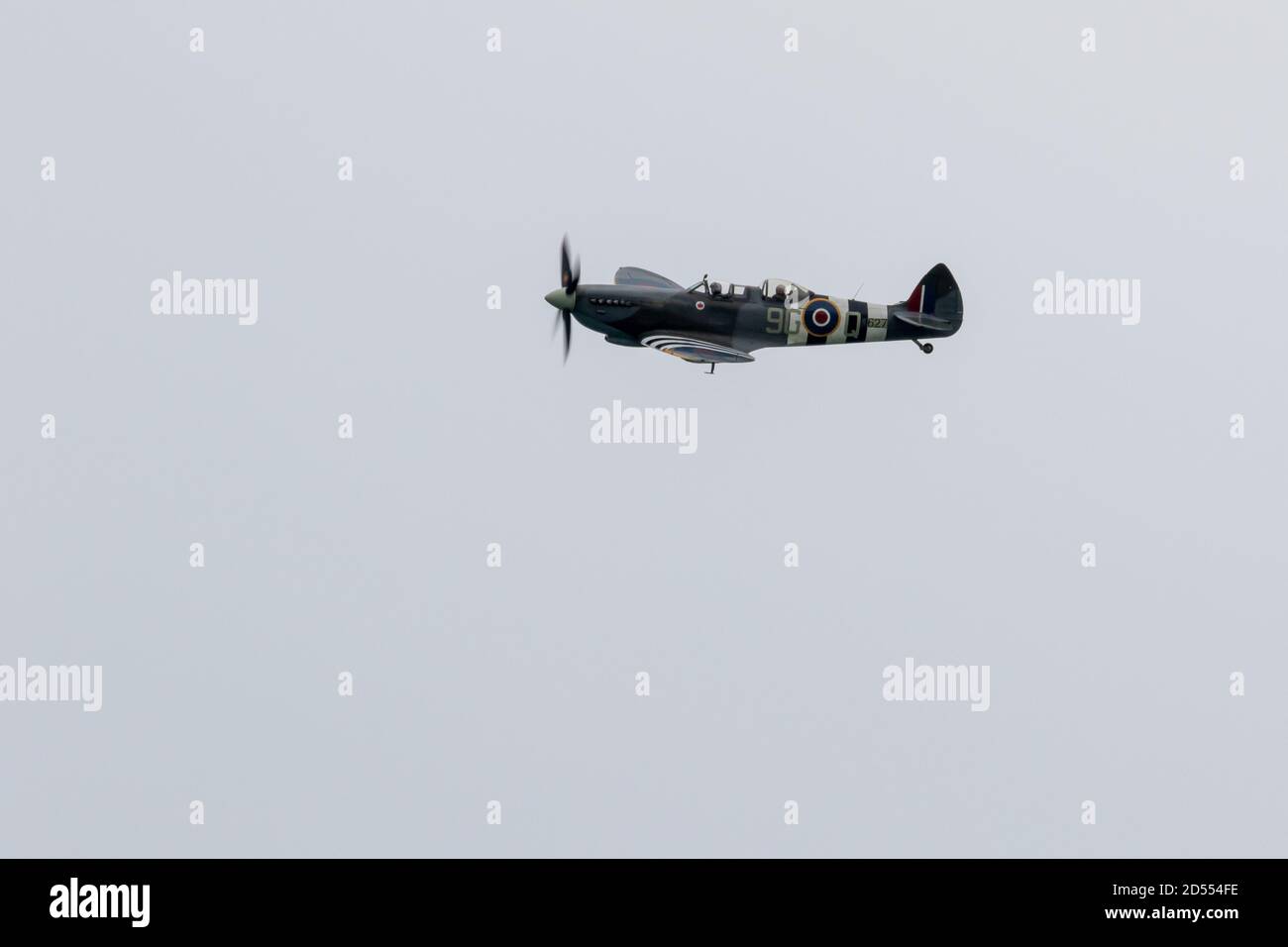 Spitfire (TR9) flies during cloudy weather at Beachy Head. Stock Photo