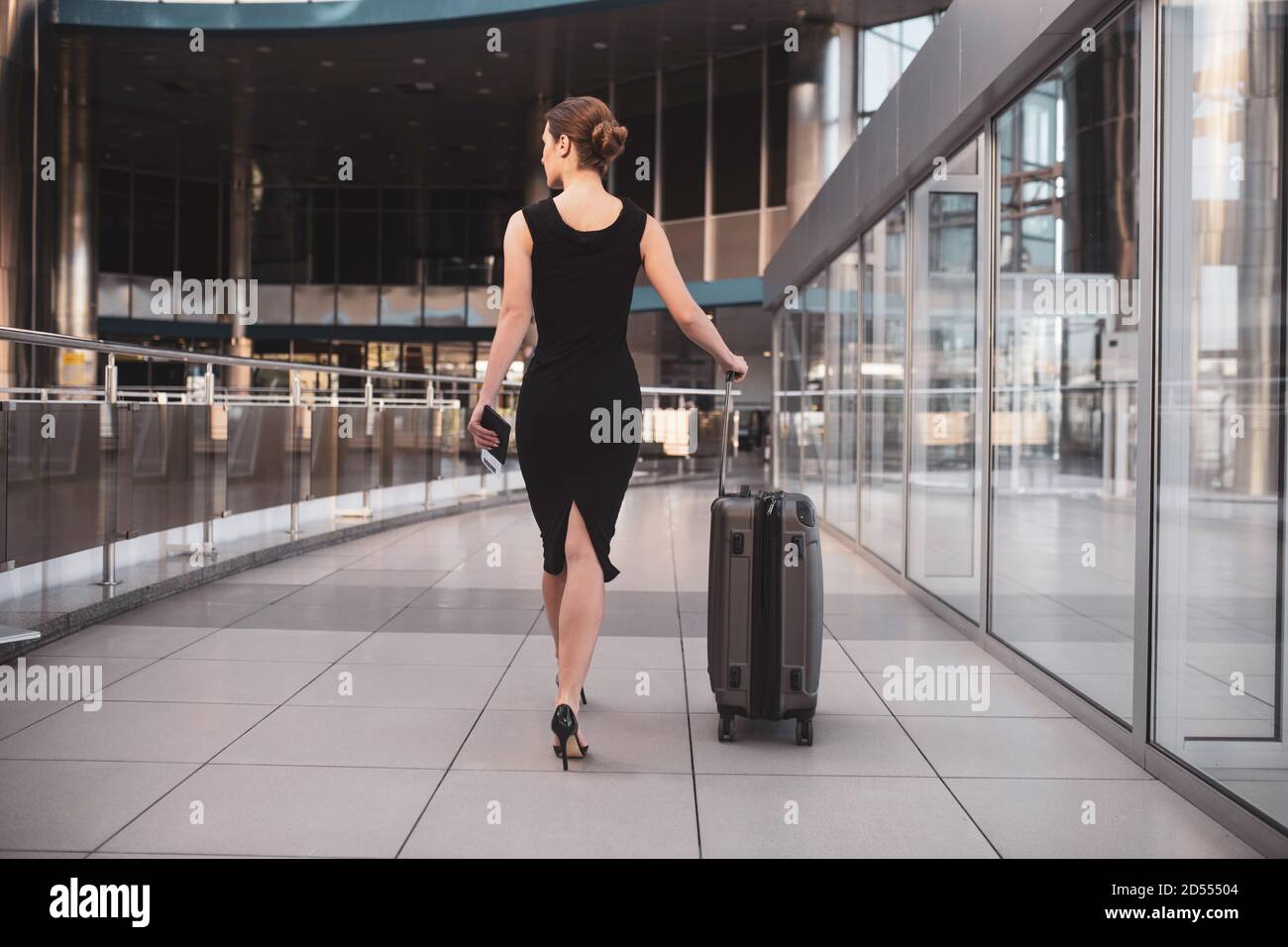 Elegant business lady walking through the airport terminal Stock Photo