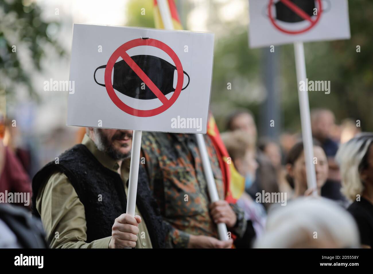 Bucharest, Romania - October 10, 2020: People display anti face masks wearing banners during a political rally. Stock Photo