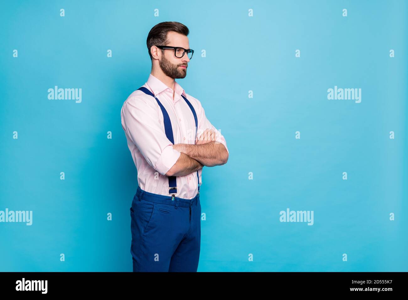 Profile photo of handsome business man trend clothes eyesight specs arms crossed look side empty space successful worker wear shirt suspenders pants Stock Photo