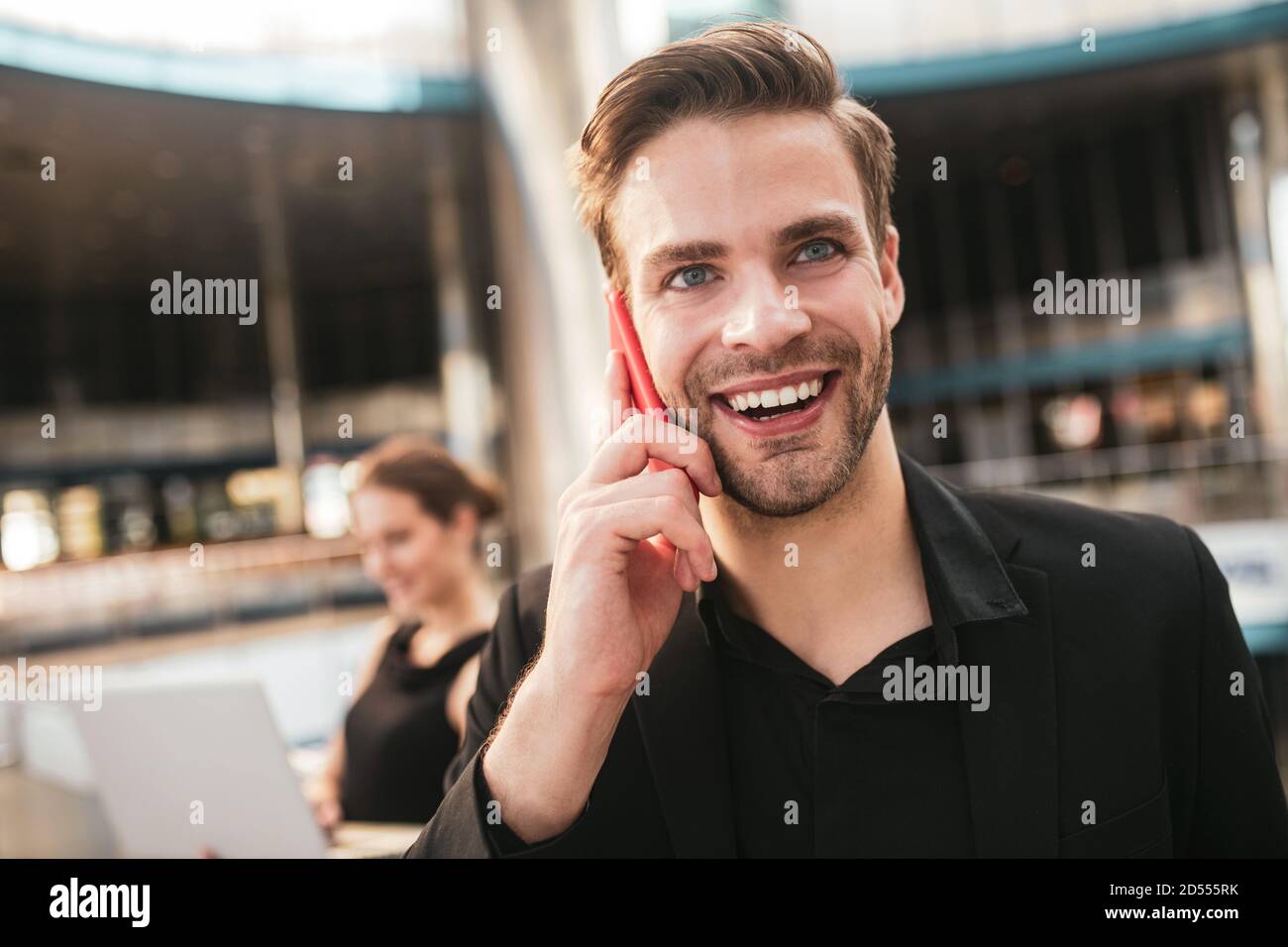 Joyful handsome man making a business phone call Stock Photo