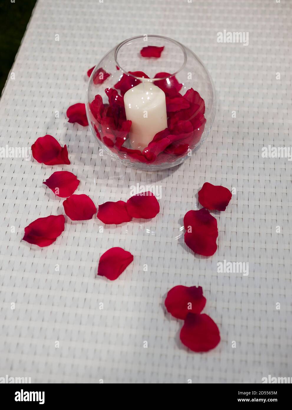 Ornamental candle with red rose petals Stock Photo - Alamy