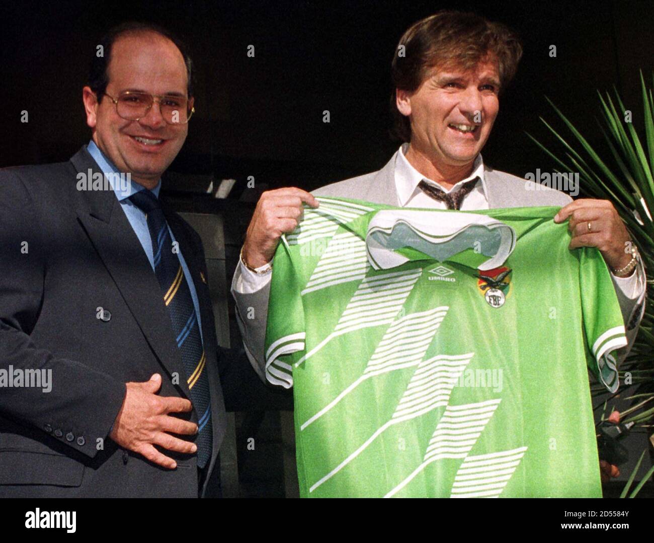 Argentine Hector "Bambino" Veira (R), shows off the new jersey that was  presented to him by the President of the Bolivian Federation of Soccer  Sergio Asbun, Nov. 10. Veira signed a four-year