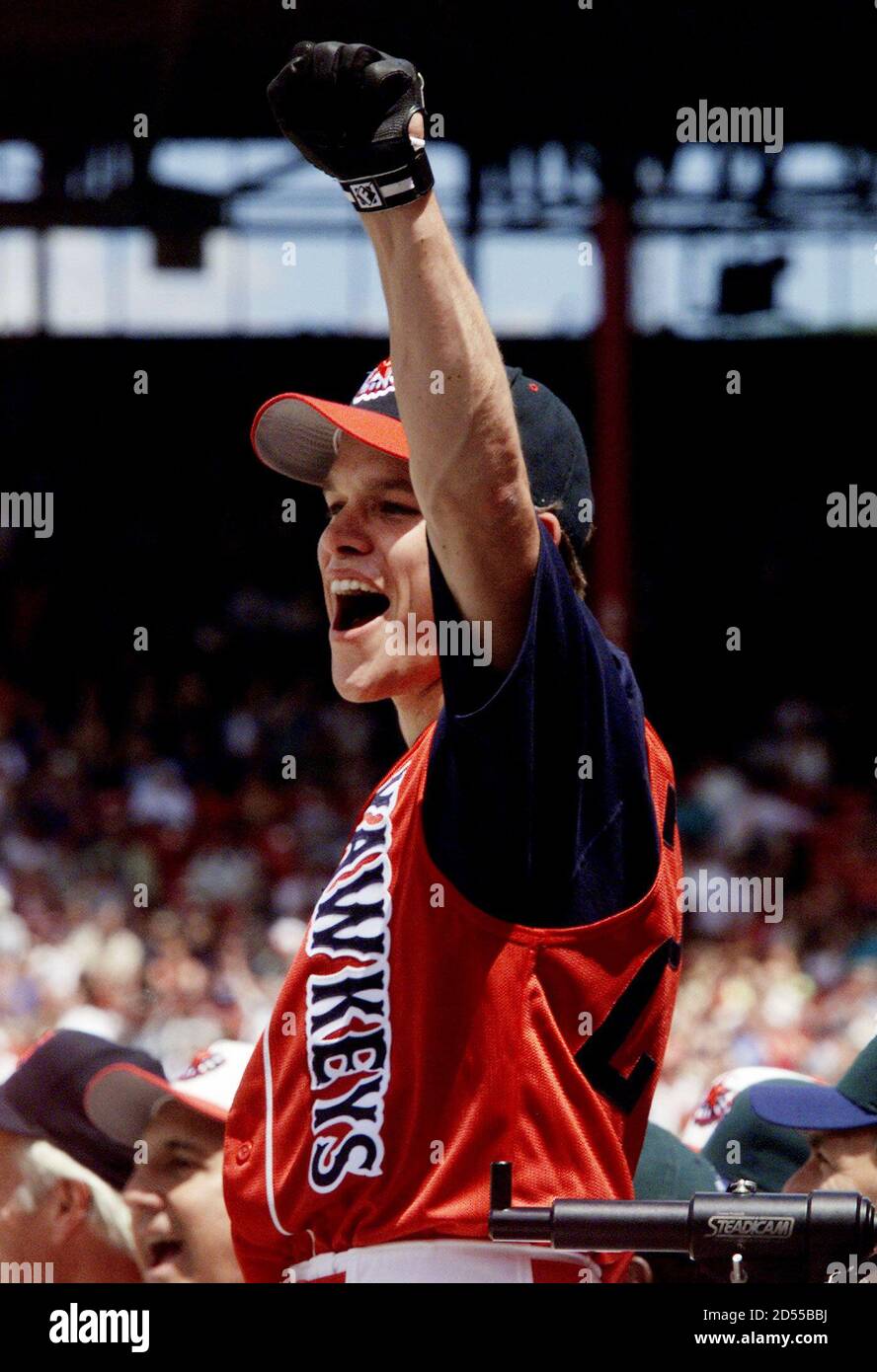Actor Matt Damon, star of the movie "Good Will Hunting," celebrates as  former Boston Red Sox slugger Jim Rice hits a home run, helping Damon's  team, the Yawkeys, win the Major League