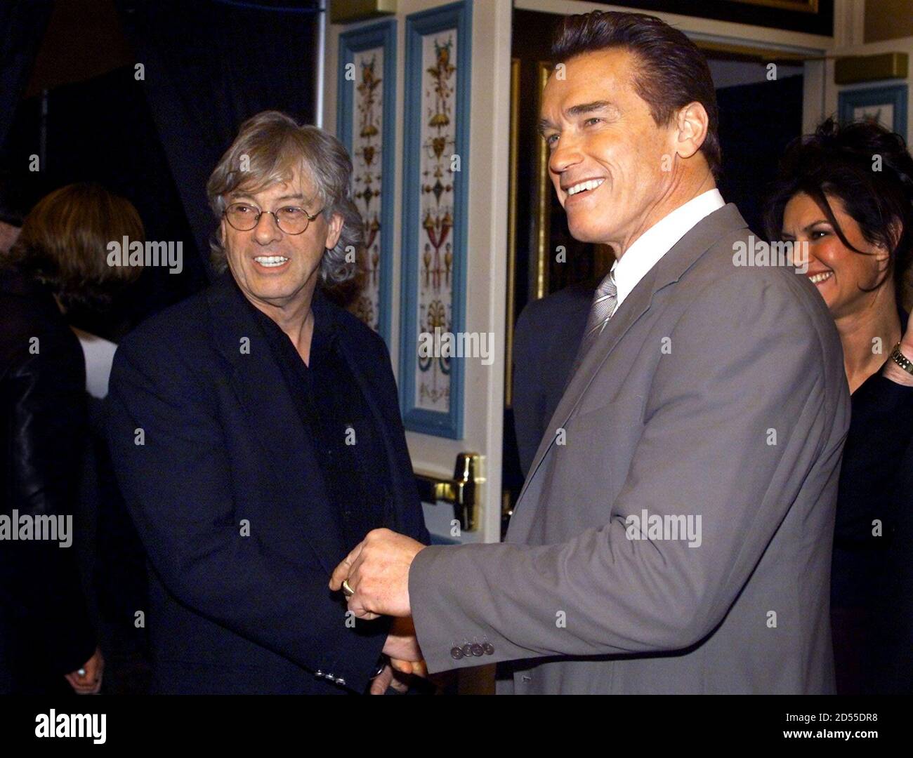 Director Paul Verhoeven greets Arnold Schwarzenegger (R) at a Columbia Pictures luncheon during the ShoWest convention March 8 in Las Vegas. [Verhoven is promoting his new film 'Hollow Man' about a scientist (Kevin Bacon)who discovers an invisibility formula. Schwarzenegger stars in 'The Sixth Day', a science fiction action film about human cloning that is scheduled to be released this fall. ] ShoWest is an annual convention and trade show for movie theater owners. Stock Photo