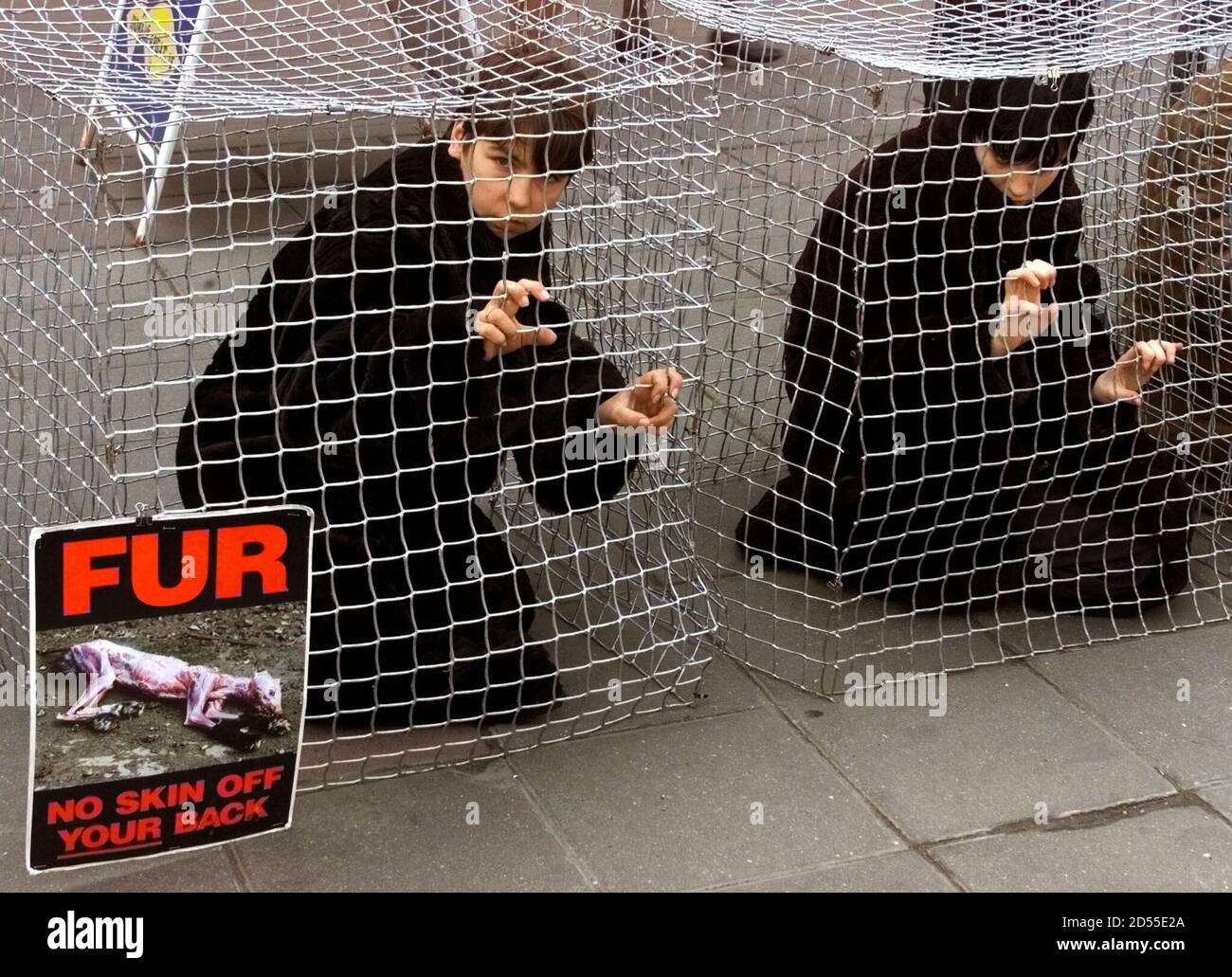PETA members, wearing fur coats, sit inside wire cages during a protest  performance April 13. The People for the Ethical Treatment of Animals  (PETA) organisation held the action to show how cruelly