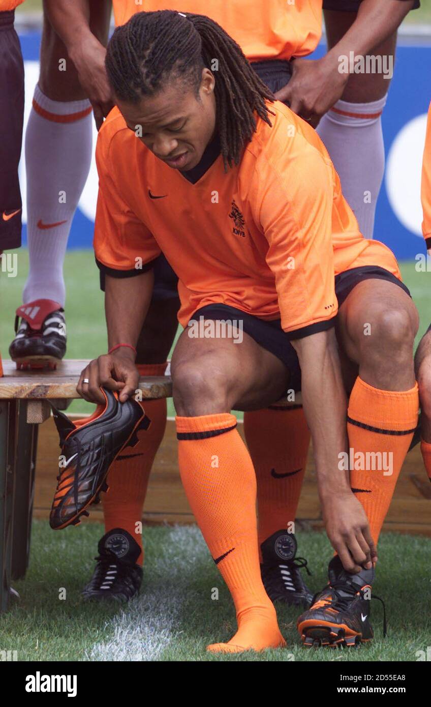 Dutch soccer player Edgar Davids puts on his left football boot in  preparation for a photo shoot in Nyon May 29. Davids has an infection due  to a ingrowing large toe nail