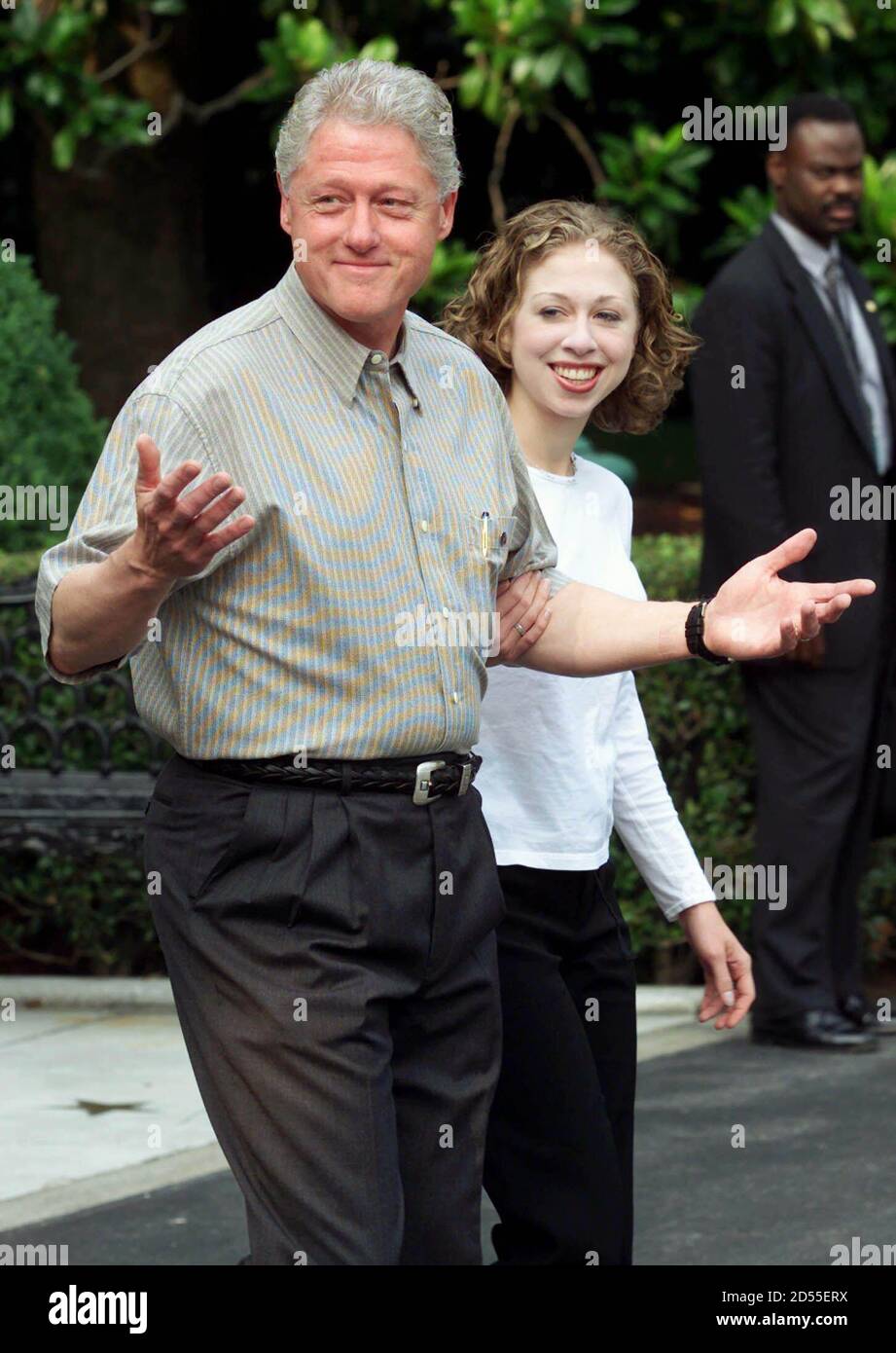 U.S. President Bill Clinton (L) shrugs in answer to the certianty of peace  in the Middle East as he leaves for Camp David with his daughter Chelsea  (R) from the White House