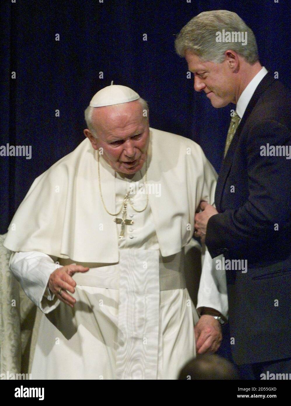 pope-john-paul-ii-is-helped-from-his-chair-by-president-clinton-after