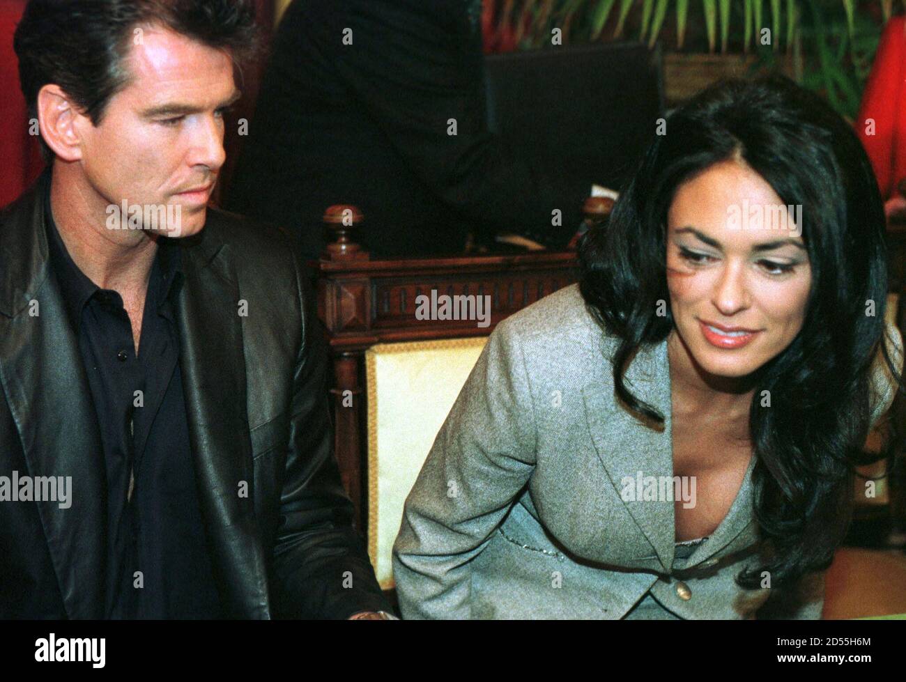 Actor Pierce Brosnan looks at Italian actress Maria Grazia Cuccinotta upon arriving in Bilbao airport February 15. Brosnan and Cuccinotta will film in Spain some sequences of the new James Bond film "The World is not Enough", also starring [Robert Carlyle, Serena Scott Thomas, Denise Richards and Sophie Marceau.] Stock Photo