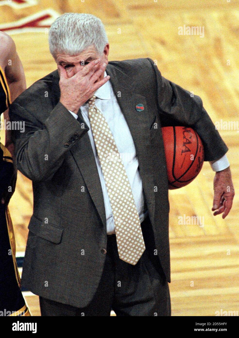 University of Iowa Hawkeyes head coach Tom Davis wipes tears from his eyes  after being hugged by his team and defeating Arkansas 82-72 in the West  Regional NCAA second round game in