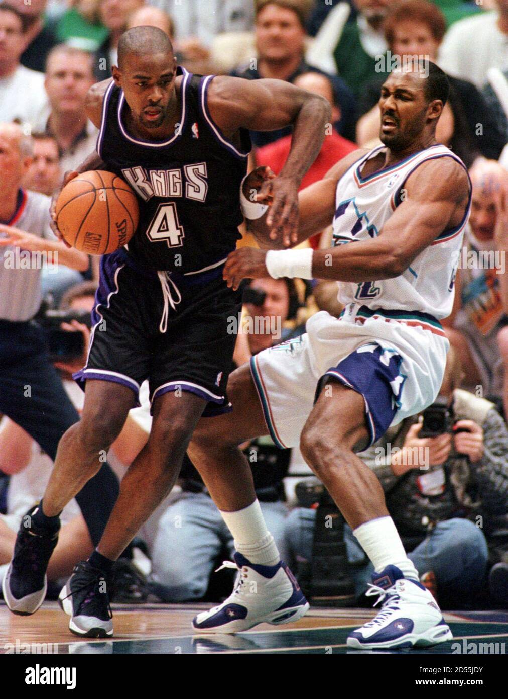 Sacramento Kings forward Chris Weber (R) shoots a hook shot over Utah Jazz  forward Karl Malone during the fourth quarter of their NBA playoff game in  Salt Lake City, May 10. scw/Photo