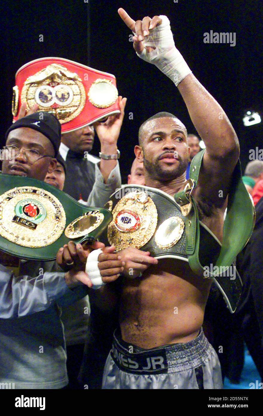 Undisputed Light Heavyweight World Champion Roy Jones Jr. (C) celebrates  with his championship belts in the ring at New York's famed Radio City  Music Hall January 15 after defeating challenger David Telesco