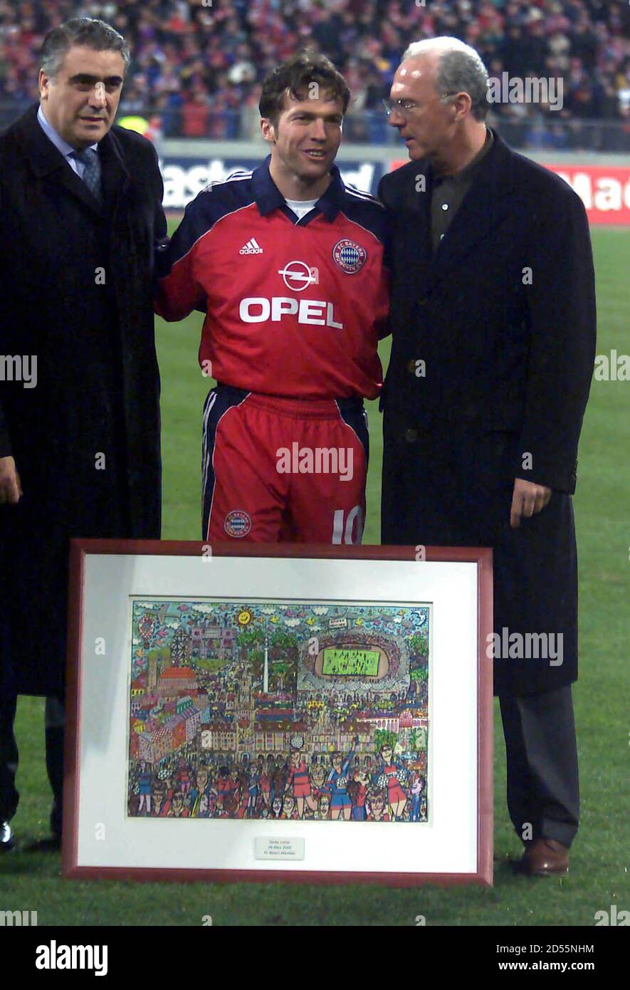 Lothar Matthaeus of Germany's Bayern Munich receives a painting of New Yory artist James Ritzi from Bayern president Franz Beckenbauer (R) and Real Madrid's Lorenzo Saints (L) prior to their Champions League group C match in Munich's Olympic stadium March 8. The match is the last for Matthaeus with Bayern Munich prior to his move to New York on March 10.  KP/ME Stock Photo