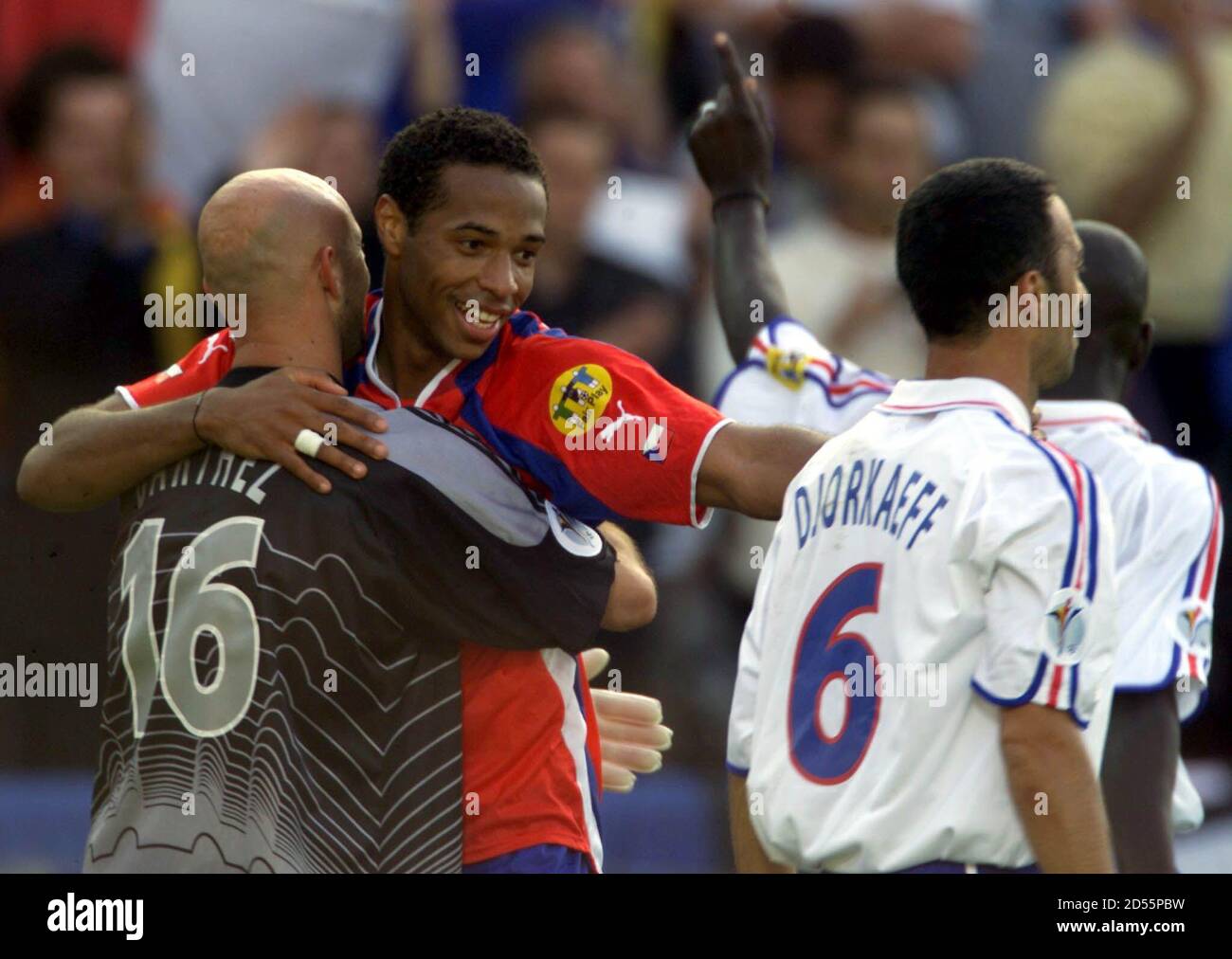 French Goalkeeper Fabien Barthez L Hugs Teammate Thierry Henry 2nd L Fellow Goal Scorer Youri Djorkaeff 2nd R And Sylvain Wiltord R Leave The Field After Their Group D European Championship Match