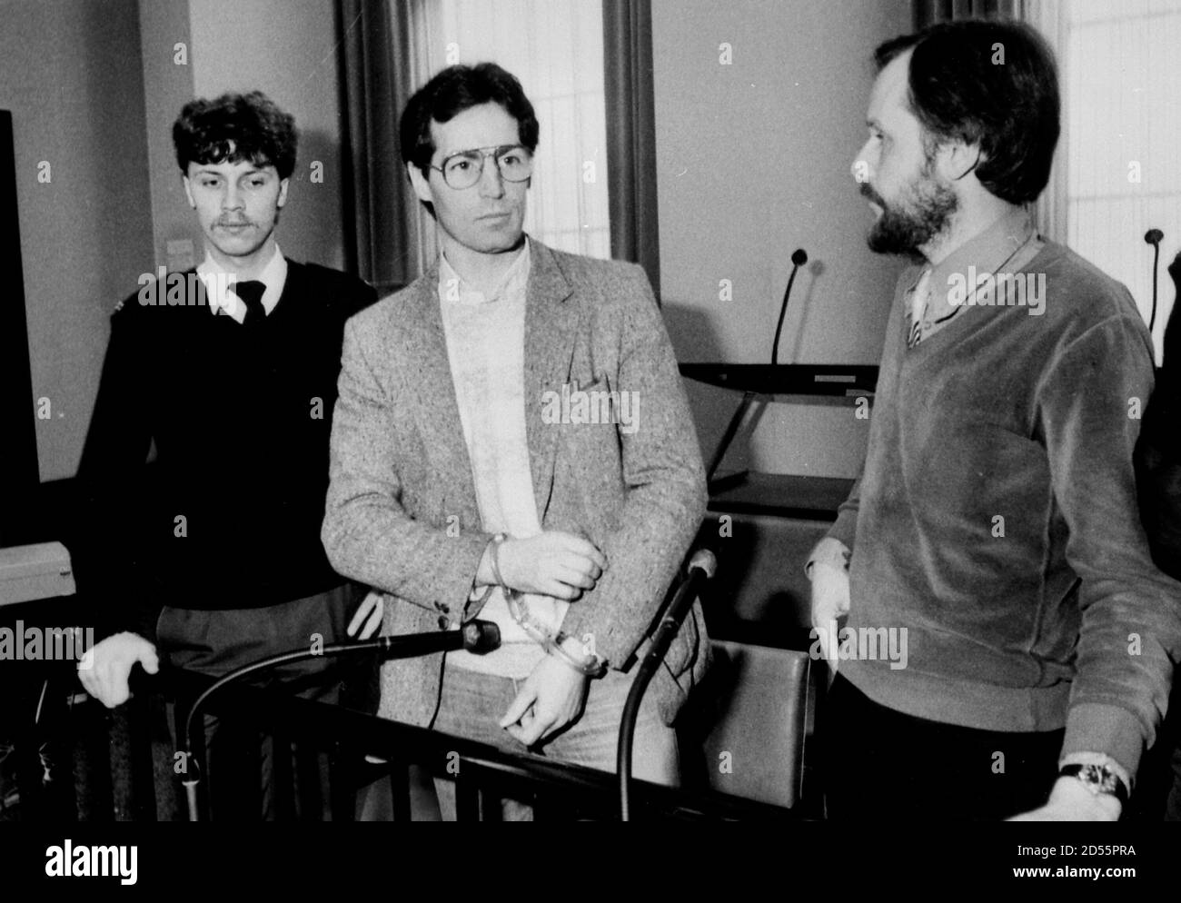 Gerard Kelly, a prominent member of the Irish Republican Army (IRA), sits between a policeman and a court interpreter during a hearing of a British request for his extradition, in Amsterdam March 25, 1986.  REUTERS/Hans Van Dijk (THE NETHERLANDS) BEST QUALITY AVAILABLE Stock Photo