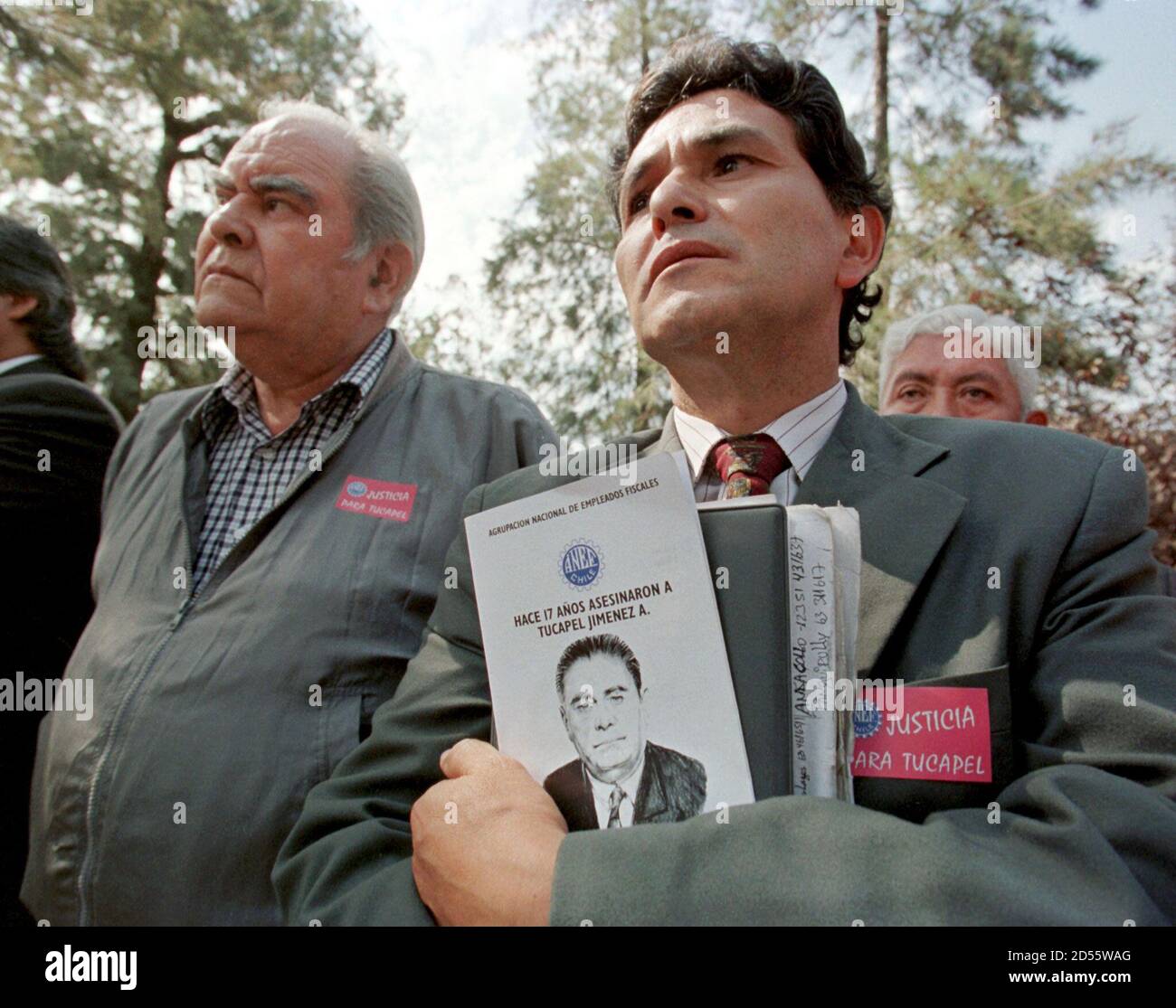 Two Men Mourn The Death Of Former Union Leader Tucapel Jimenez During A Memorial Service In Santiago February 25 Jimenez Who Was The Leader Of The Public Workers Union Was Killed By