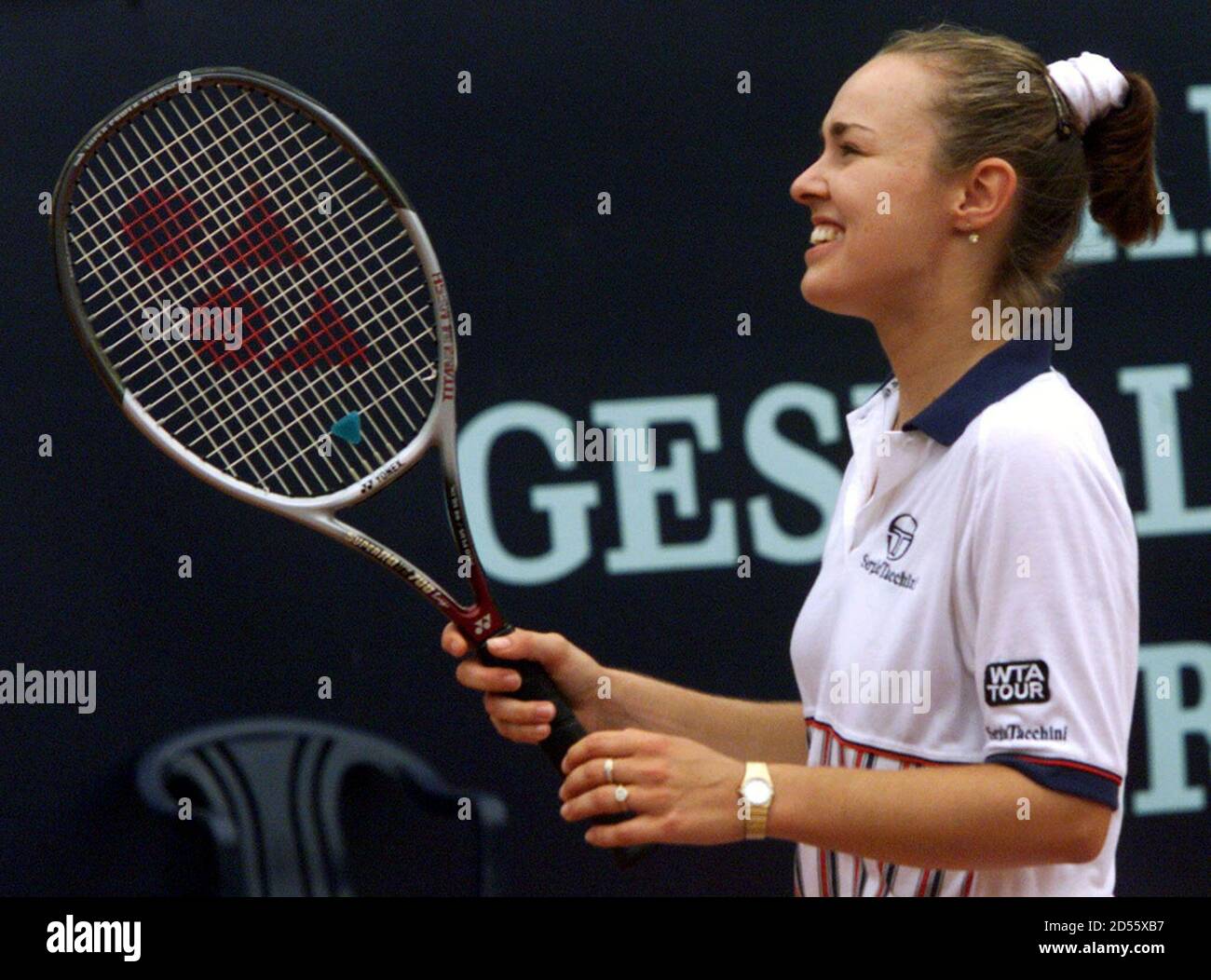 Swiss tennis player Martina Hingis holds up her racket after winning her  match against Gala Leon Garcia at the WTA tour German Open tennis  tournament in Berlin May 12. Hingis won her