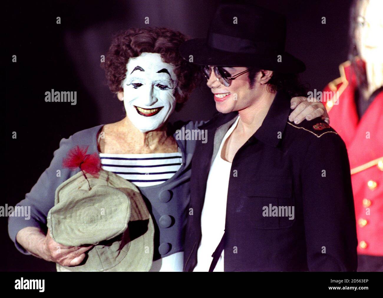 American pop star Michael Jackson (R) poses with French mime artist Marcel  Marceau on stage at the Grevin Museum April 19. Jackson inaugurated his wax  double executed from four pictures.The singer offered