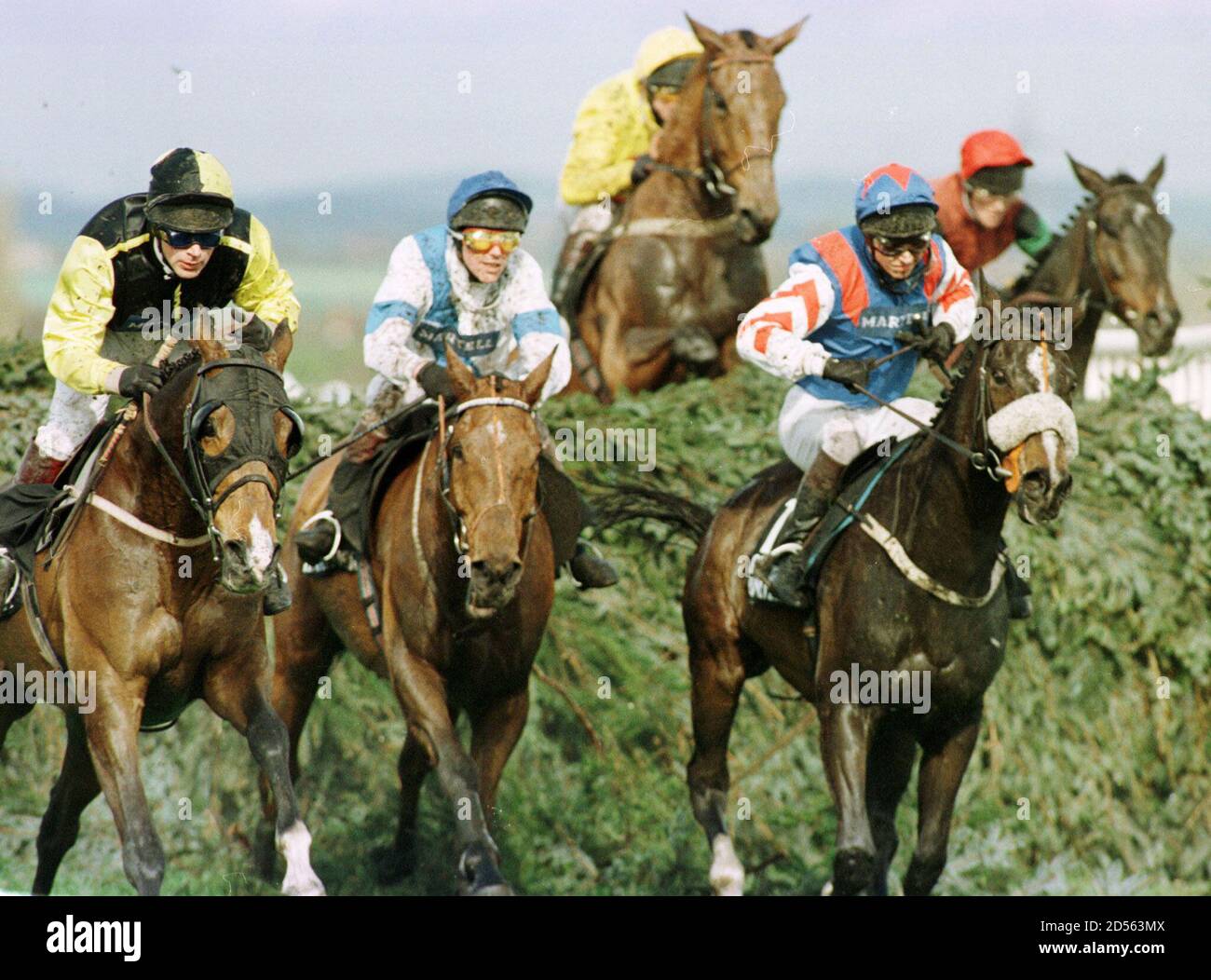 Jockey Carl Llewellyn Rides The Grand National Winner Earth Summit L Away From The Chair Hurdle With Brave Highlander C And Go Universal R Keeping Up The Pace April 4 The Race