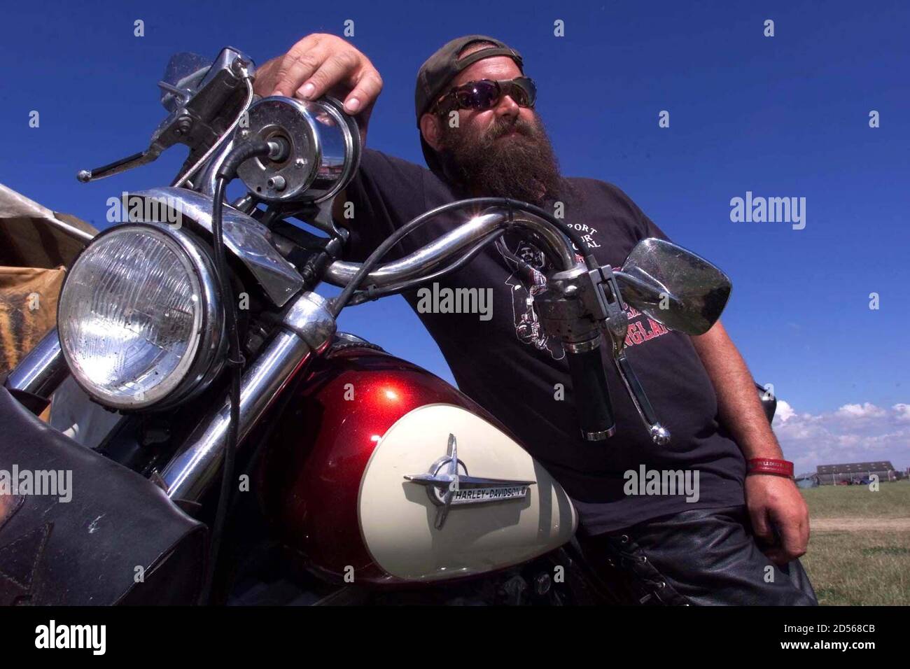 A Hells Angel biker leans on his Harley Davidson at The Bulldog Bash at Long Marston airfield in Warwickshire August 5. The event which is the largest of its kind in Europe is expected to attract around 40,000 bikers over the four day festival.  IH/JRE Stock Photo