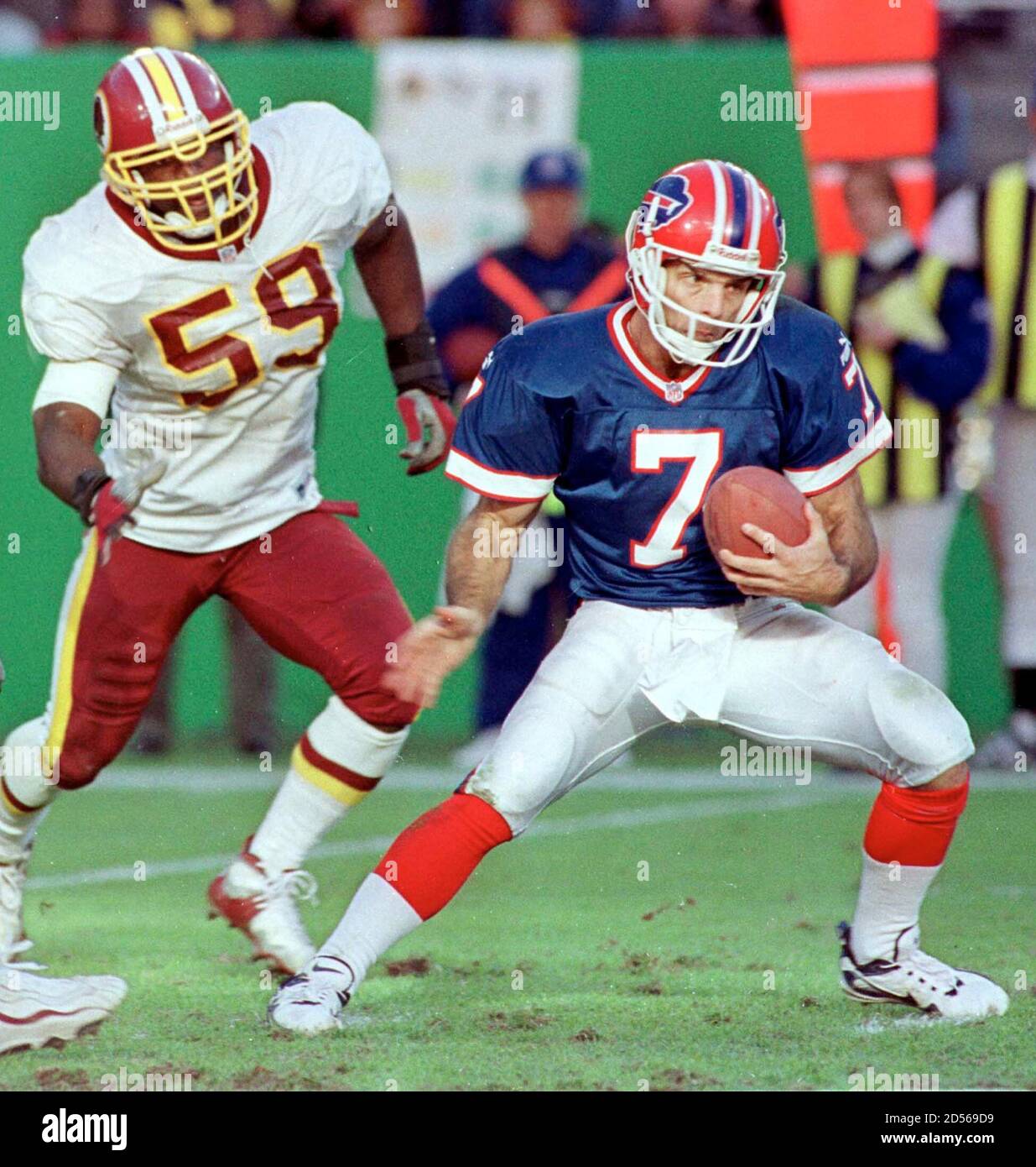 Buffalo Bills quarterback Doug (7) spins from rush from Washington Redskins' Shawn Barber (59) during the third quarter at Redskins Stadium November 7. Buffalo went on to win the