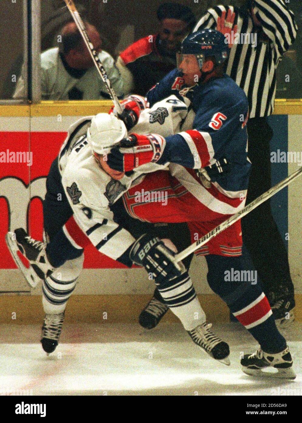 Toronto Maple Leafs' forward Fredrik Modin (L) gets roughed up at the blue line by New York Rangers' defenseman Ulf Samuelsson during first period NHL action in Toronto, December 19.  ANW/RC Stock Photo