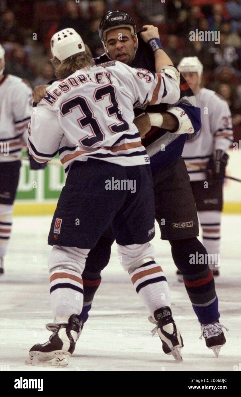 Edmonton Oilers Marty Mcsorley 33 And Vancouver Canucks Donald Brashear Duke It Out During A First Period Fight January 14 At General Motors Place In Vancouver Mcsorley Received Two Minutes For Instigating