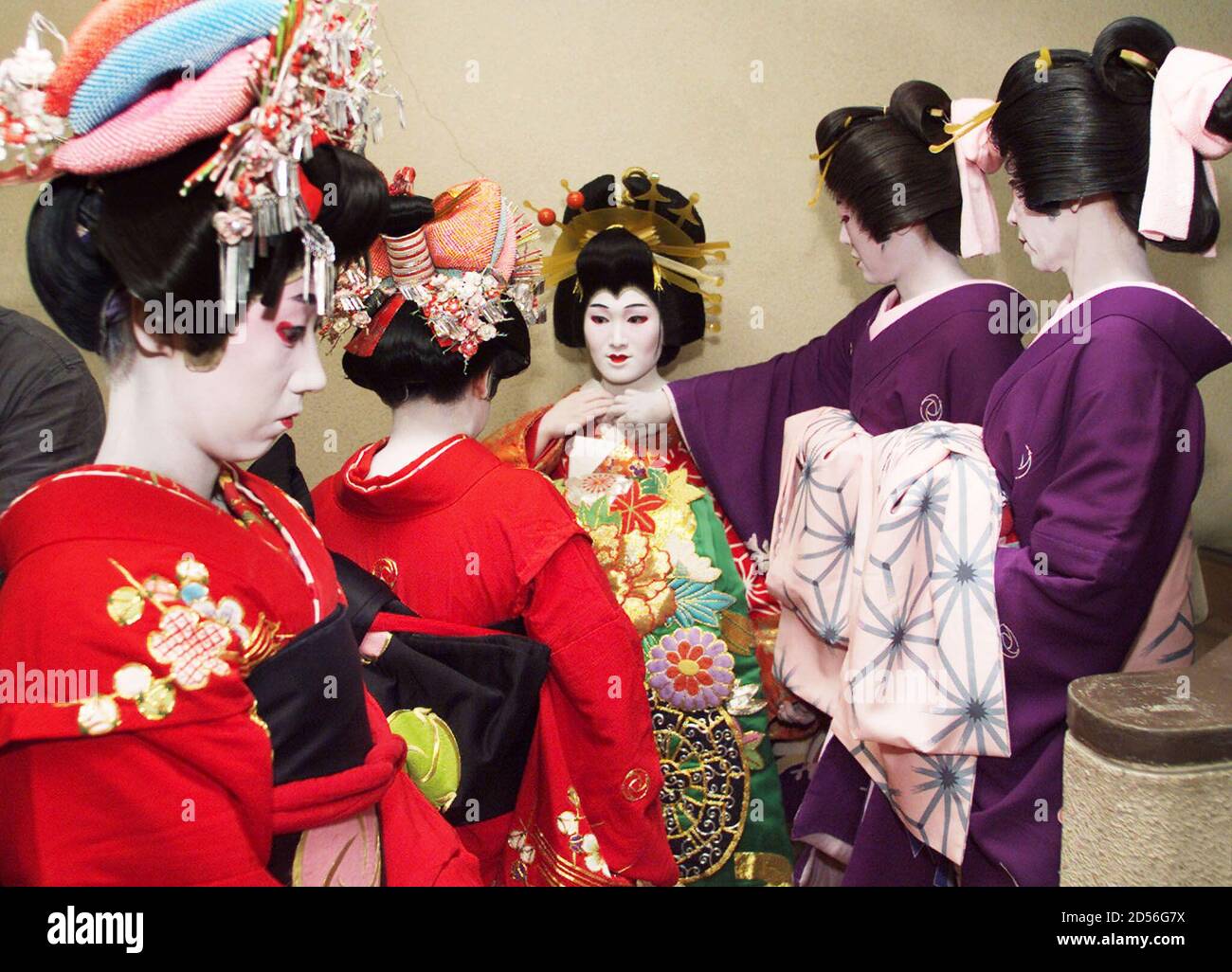 Oiran" (C) and kimono-clad attendants wait for the curtains to rise for her  performance as a 17th century high-ranking courtesan in Edo, the current  Tokyo, at an Asakusa theatre July 16. The