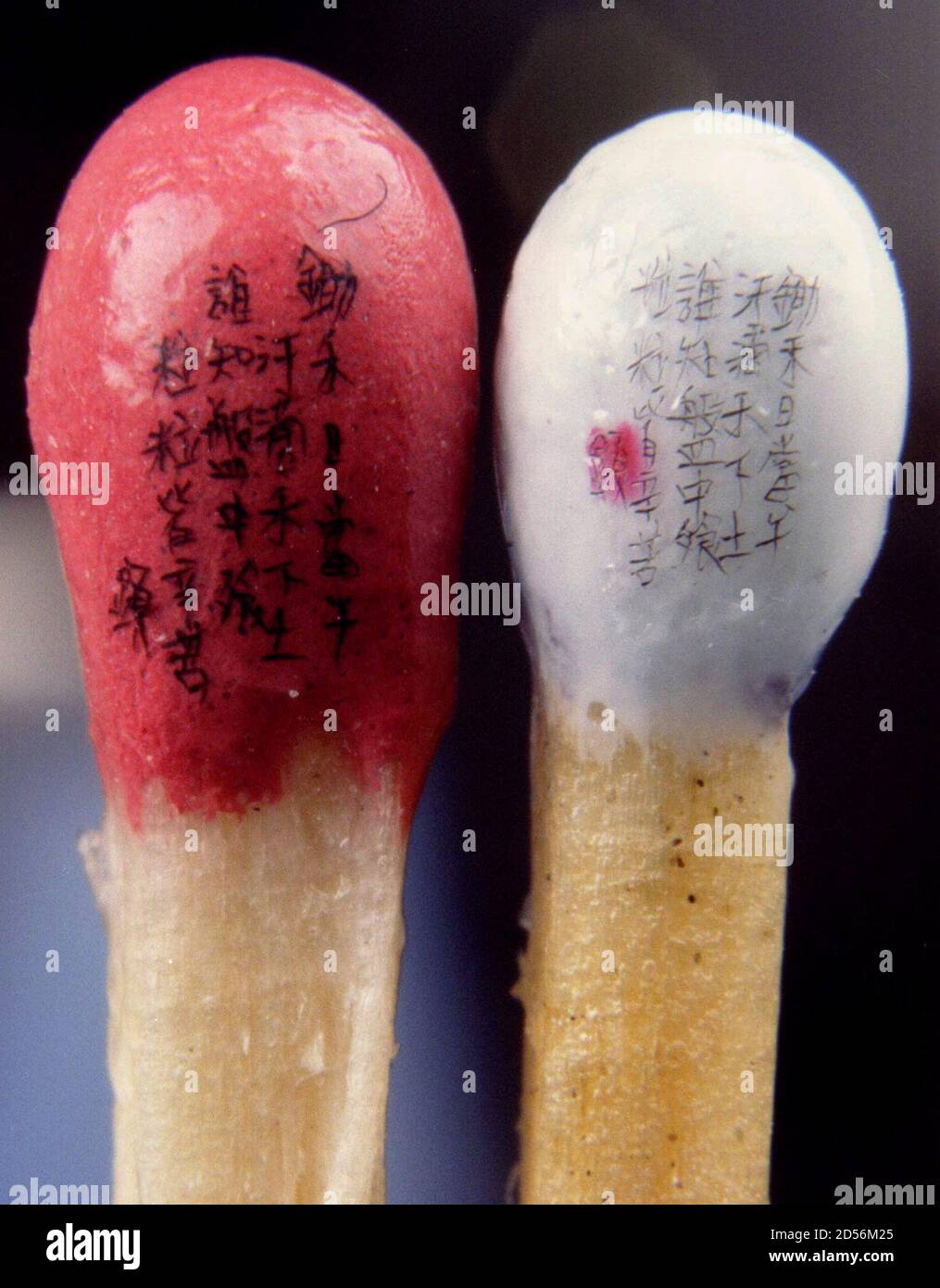 Two poems appear on the tips of two matches, written by renowned Taiwanese artist Chen Feng-hsien are display in Taipei June 3. Because the 0.5-cm tips are water-absorptive, Chen said he had to cover them with a thin coating before writing the words Stock Photo