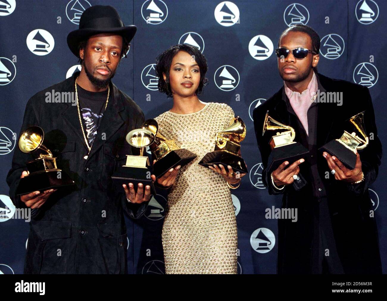 The Fugees (from left) Wyclef Jean, Lauryn Hill and Prakazrel Michel pose  with the Grammy they won for the Best R & B Performance by a Duo or Group  for "Killing Me