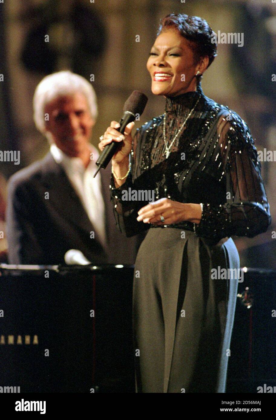 Dionne Warwick (R) sings a Burt Bacharach song while Burt (L) plays the piano during the taping of a Turner Network Television special 'Burt Bacharach: One Amazing Night' in New York on April 8. [The special brought out numerous musical celebraties to sing Bacharach tunes, including Elvis Costello, Sheryl Crow, Chrissie Hynde and Luther Vandross. The show will air April 15.] Stock Photo