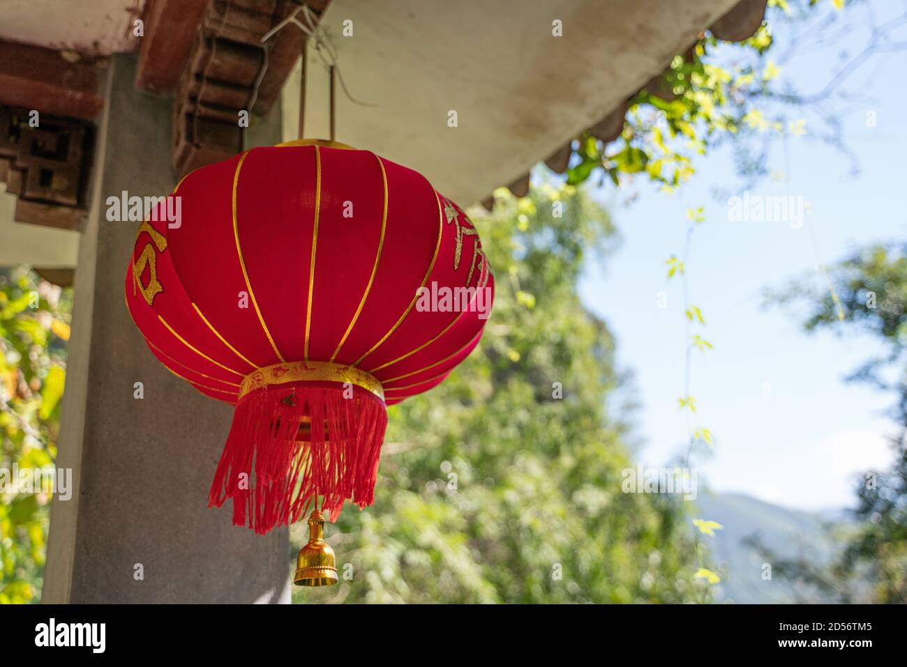 A traditional Chinese red lantern hanging in a gazebo Stock Photo - Alamy