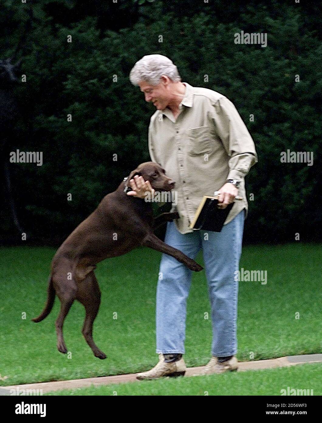 President Bill Clinton plays with his dog Buddy as he walks from the Oval  Office, October 10. The president later departed for the presidential  retreat Camp David for an overnight stay. MW/SV