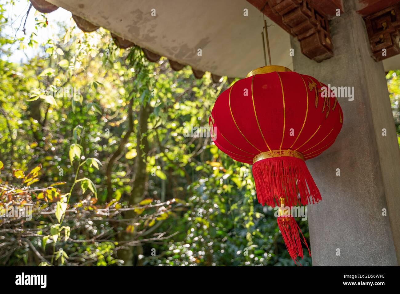 A traditional Chinese red lantern hanging in a gazebo Stock Photo - Alamy