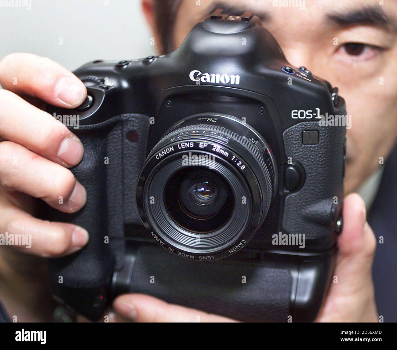 Canon Employee Yoshinobu Ohkawaguchi Holds The New Eos 1v Camera In Tokyo February 2 Canon Inc Introduced Its Flagship Professional Model Eos 1v Af Slr Camera Equipped With An Array Of State Of The Art Features Including