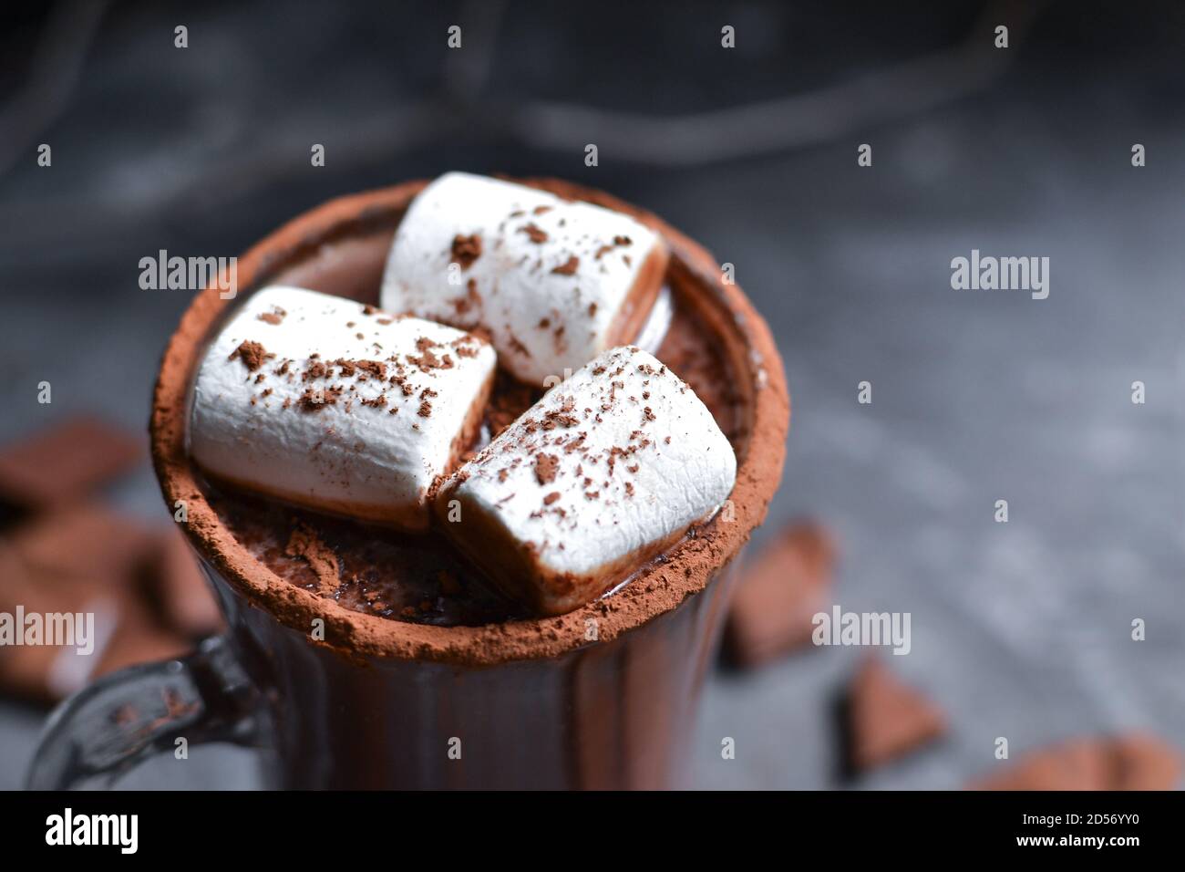 Glass cup of Hot chocolate with marshmallows in knitted cup holder with  cookies, chopping chocolate and mittens over wooden wind Stock Photo - Alamy